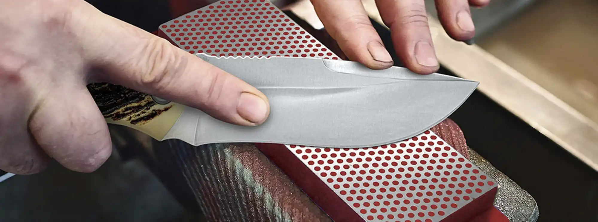 Kitchen knife being sharpened on a whetstone.